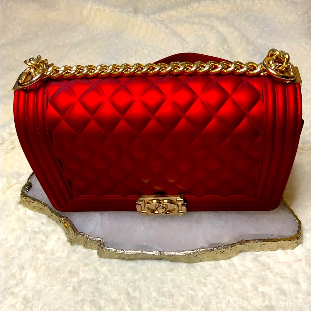 Red plastic crossbody purse with gold accents NWT